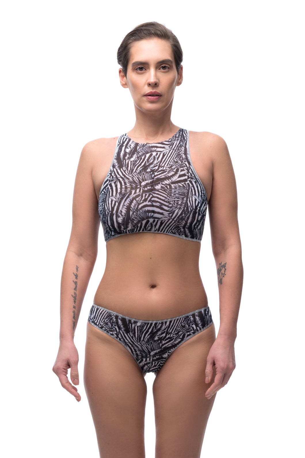 Discover sustainable tan-through smart swimsuits adorned with a trendy Fake Zebra print in this file. Featuring a sport top design, they are ideal for beach activities.