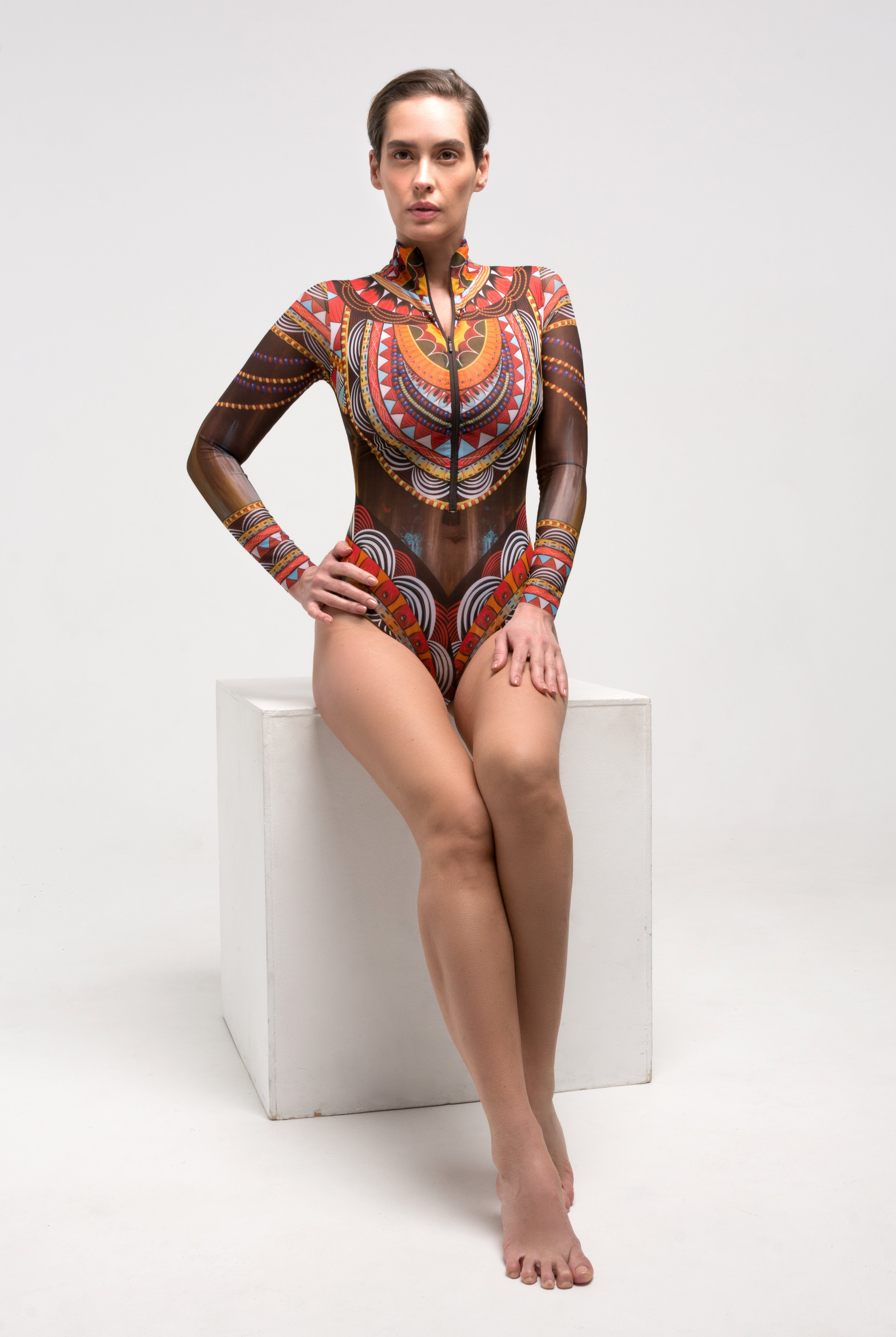 This file presents the epitome of innovation and sustainability in smart swimwear, showcasing our globally recognized brand. Featuring the Africa print, this one-piece with sleeves, zipper, and tan without tan lines technology exudes runway-worthy style