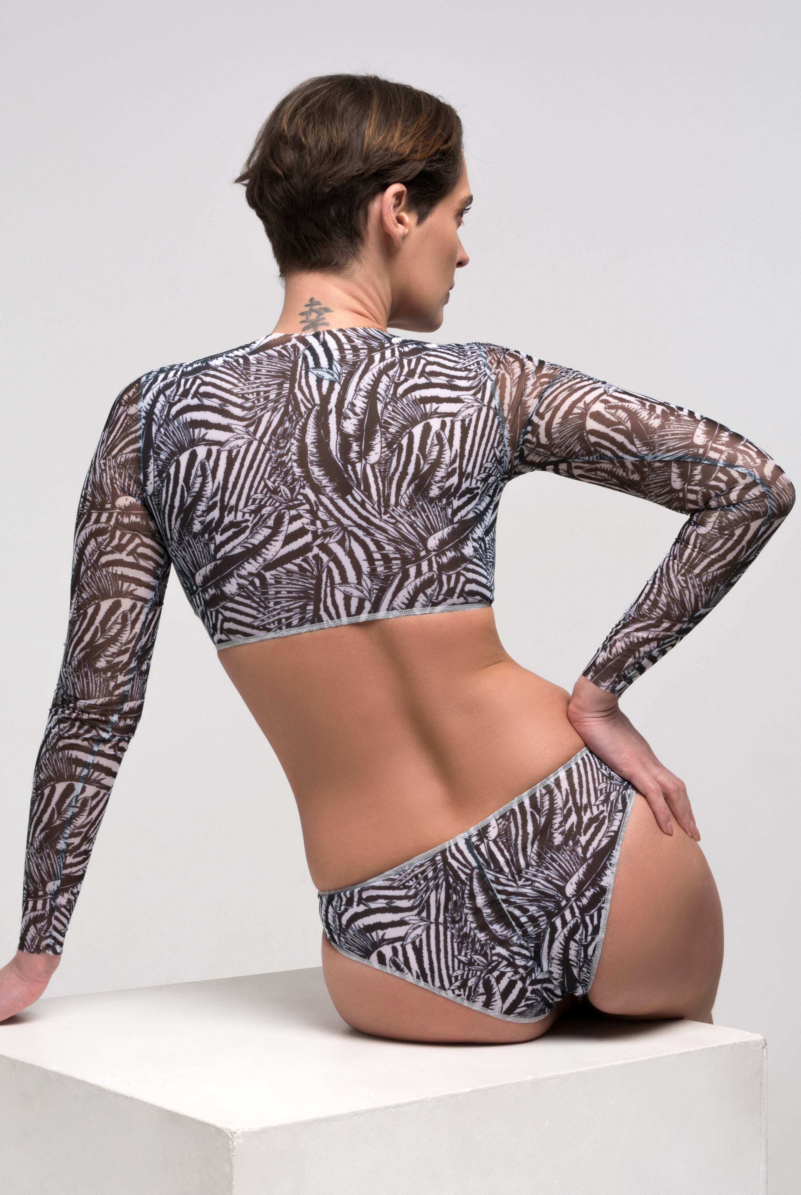 This file showcases sustainable tan-through smart swimsuits adorned with a trendy Fake Zebra print. Included is a classic bikini, offering both style and sun protection.