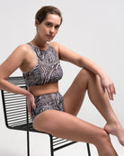 This file showcases sustainable tan-through smart swimsuits adorned with a trendy Fake Zebra print. It includes a high-waist bikini offering SPF35 protection for sun-safe sophistication.