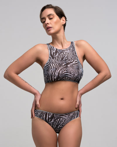This file features sustainable tan-through smart swimsuits adorned with a trendy Fake Zebra print. It includes a stylish Brazilian bikini, representing a new classic beachwear style