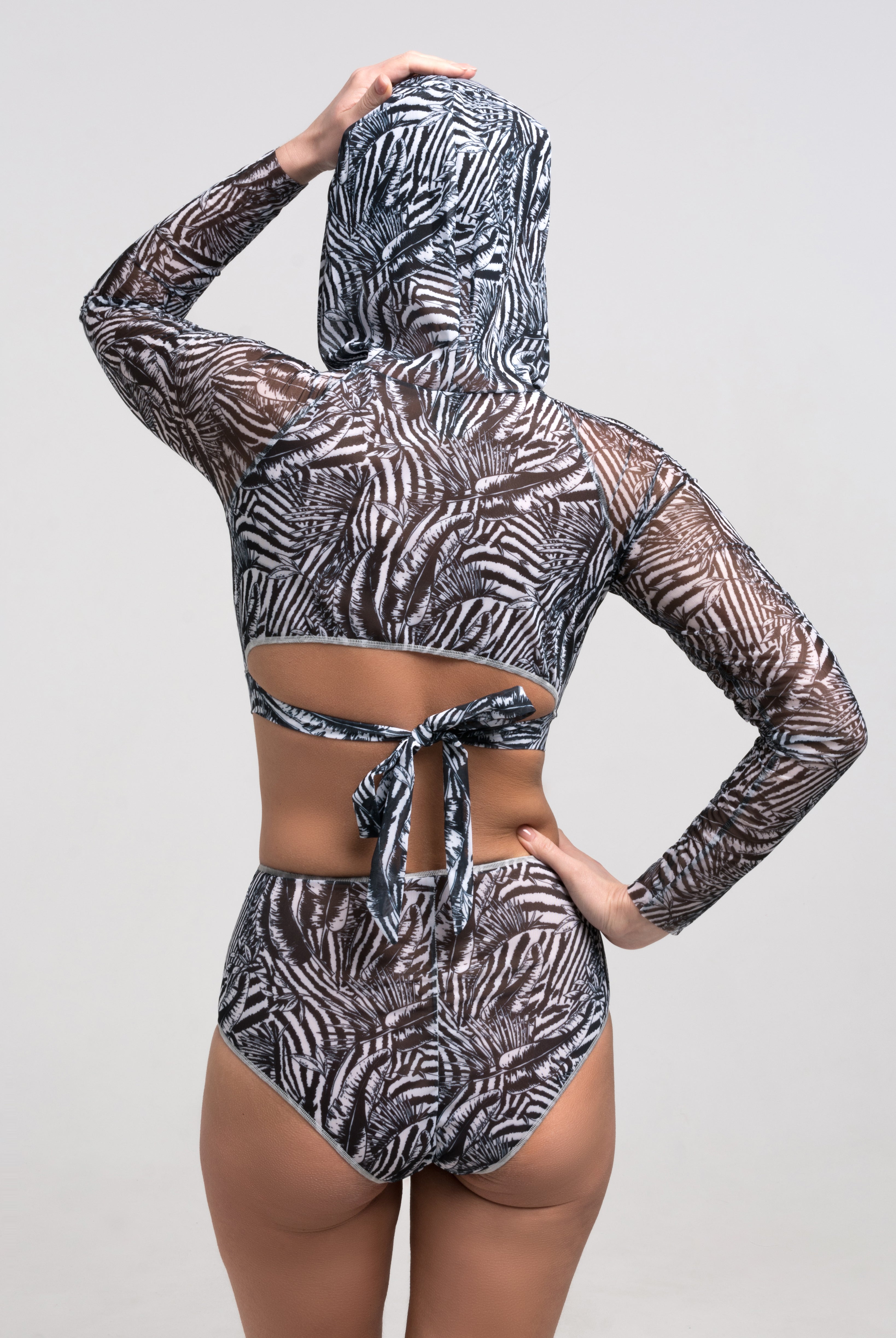 Discover sustainable tan-through smart swimsuits adorned with a trendy Fake Zebra print in this file. Featuring a high-waist bikini design, they offer both style and sun protection.