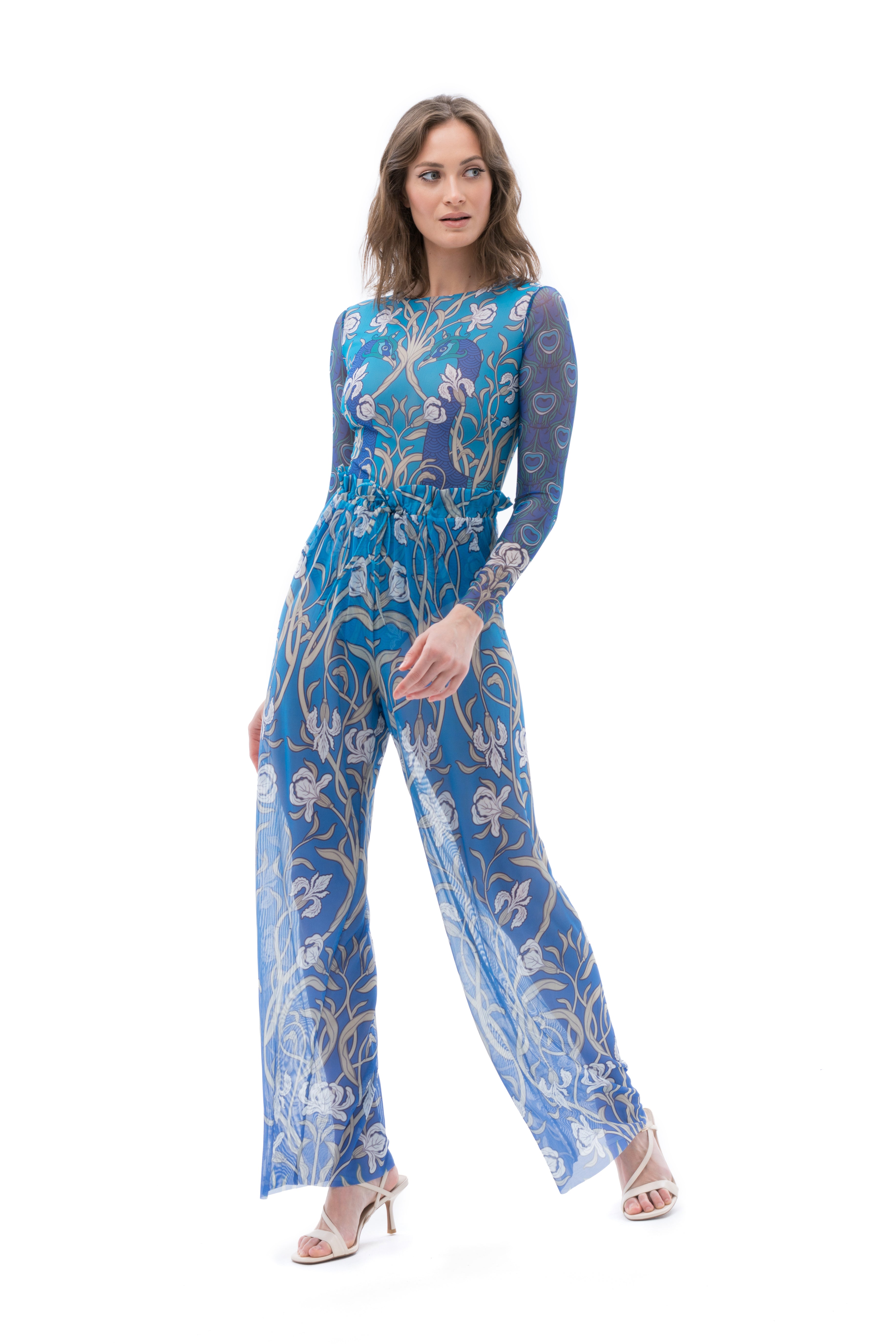 Explore our range of sustainable tan-through smart swimsuits featuring a mesmerizing peacock print. This file highlights beach pants, offering classic luxury for your beach outings.
