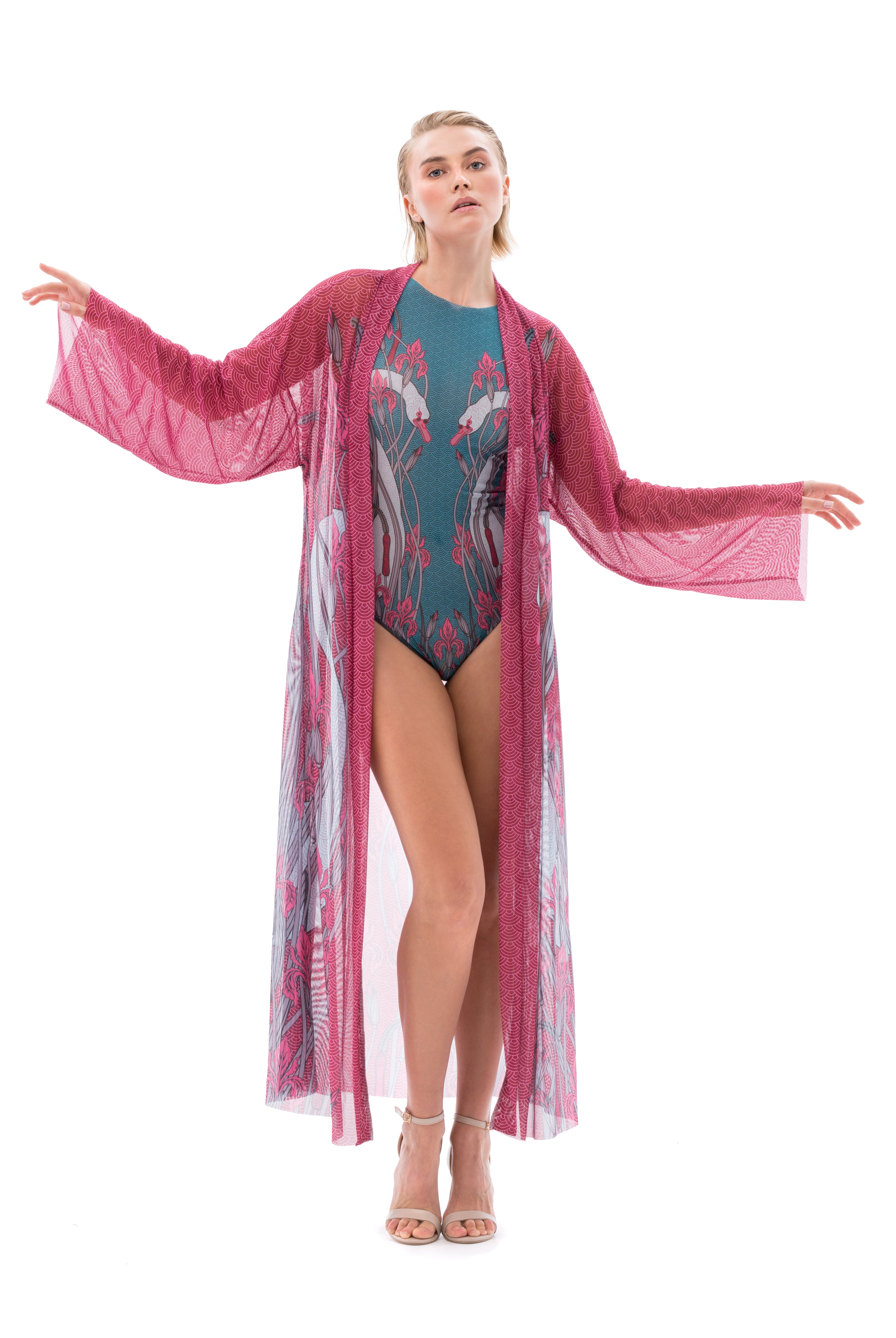  Explore sustainable tan-through smart swimsuits with a chic swans print. This file showcases beach robes with SPF15 protection, offering classic luxury and iconic style for your beach outings.