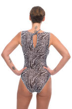 Load image into Gallery viewer, Explore sustainable tan-through smart swimsuits adorned with a trendy Fake Zebra print in this file. Featuring sleeveless one-piece designs, they offer both style and sun protection.
