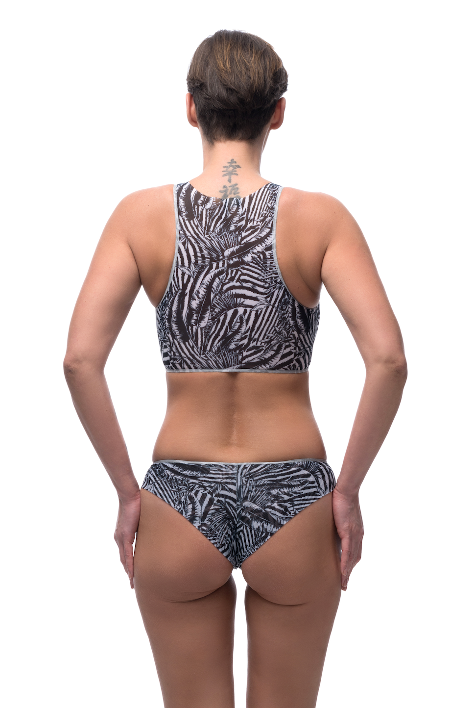 This file features sustainable tan-through smart swimsuits adorned with a trendy Fake Zebra print. Included is a sport top, ideal for beach activities. Shop now for sun-safe style!