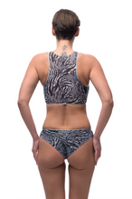 Load image into Gallery viewer, This file features sustainable tan-through smart swimsuits adorned with a trendy Fake Zebra print. Included is a sport top, ideal for beach activities. Shop now for sun-safe style!
