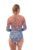 This file showcases sustainable tan-through smart swimsuits featuring the vibrant Confetti print. With a one-piece swimsuit design including sleeves, it offers a sporty, active beach style