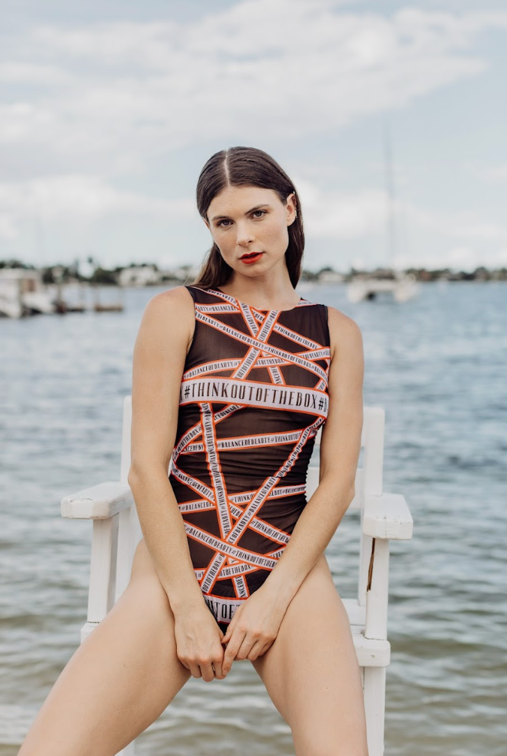This file presents tan-through sustainable smart swimsuits featuring the unique "Think Out of the Box" print. Offering SPF35 protection and classic luxury, click for timeless elegance by the beach!