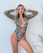Discover tan-through innovative sustainable smart swimsuits in Alkonost print. Perfect for those seeking classic luxury, this file features a one-piece swimsuit with sleeves. Click to explore more!