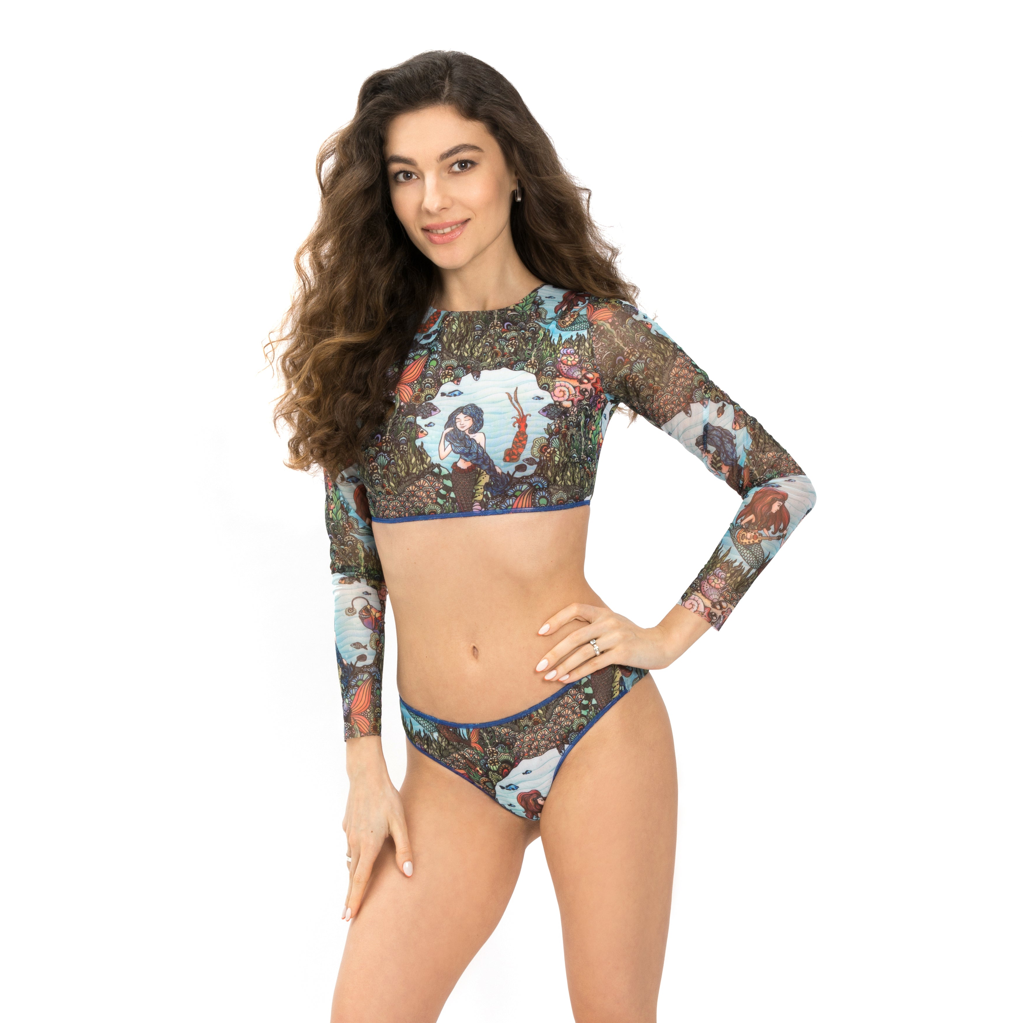 Explore our sustainable tan-through swimwear line featuring a chic mermaid print. This top with sleeves offers SPF35 protection and ensures an impeccable fit for a luxurious beach outing. Click to shop now!